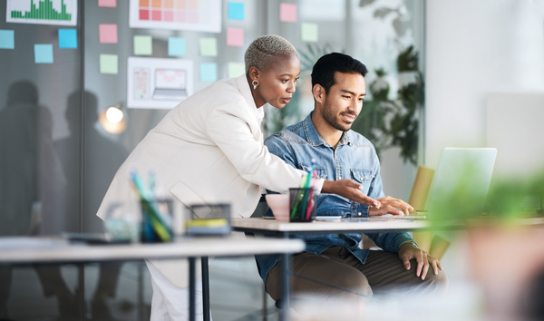 two colleagues on a laptop