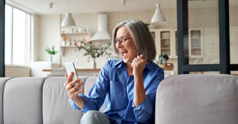 smiling woman looking at her phone