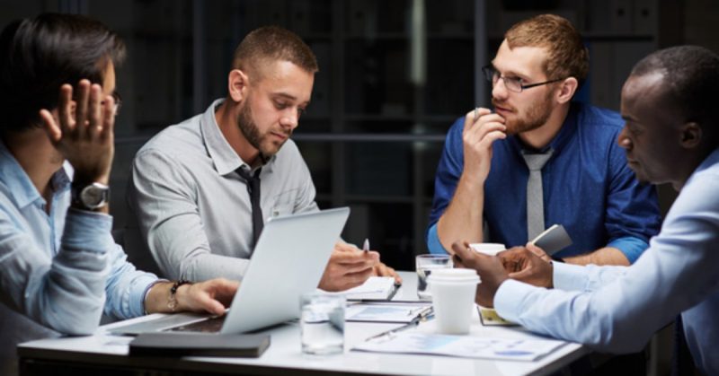 group working around a table together