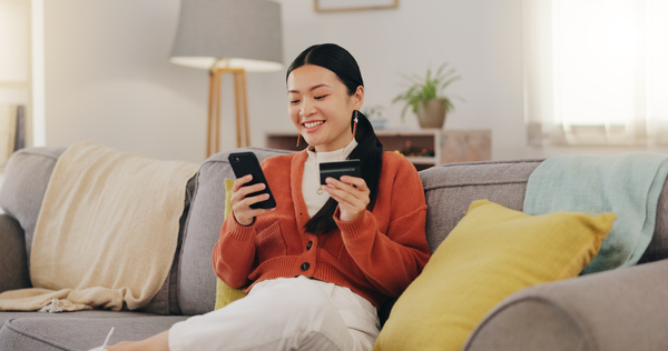 woman at home about to purchase online - servicing costs