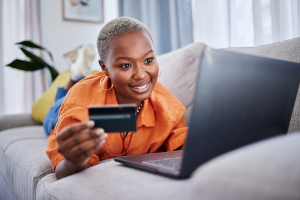 woman holding a card about to buy online - servicing costs