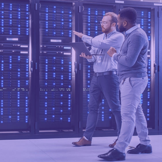 Two employees in a server room